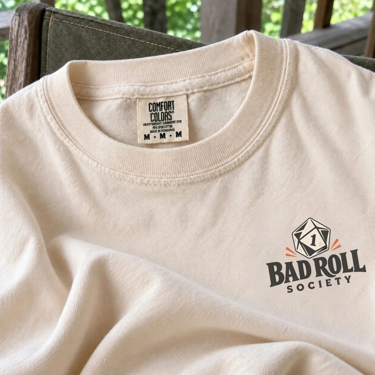 Close-up of the Comfort Colors 1717 collar and label on an ivory Bad Roll Society tee